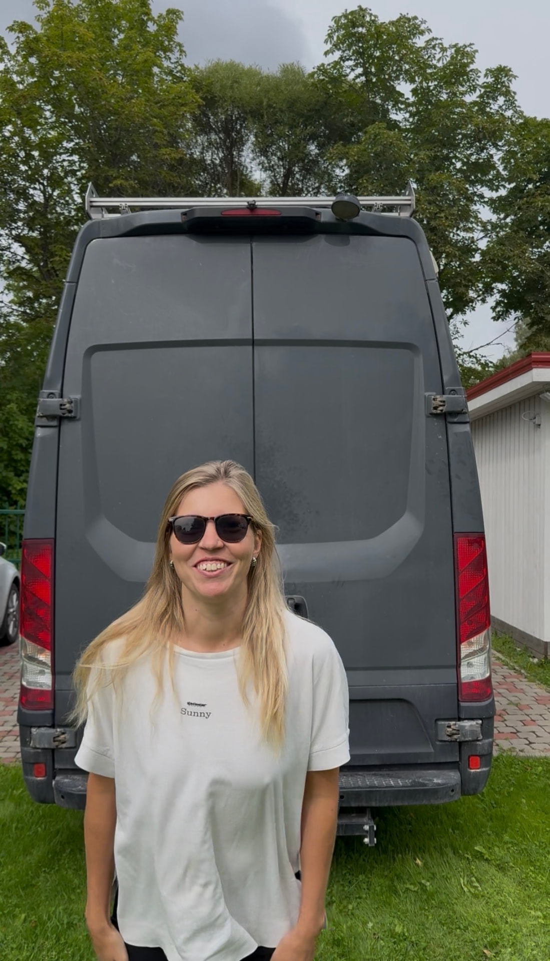 Liina smiling in front of her campervan